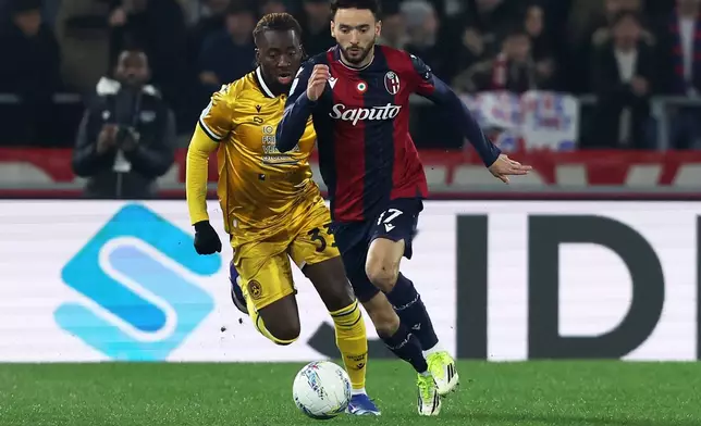 Bologna's Joao Mario, right, and Udinese's Jordan Zemura in action during the Serie A soccer match between Bologna and Udinese in Bologna, Italy, Monday Feb. 23, 2026. (Gianni Santandrea/LaPresse via AP)