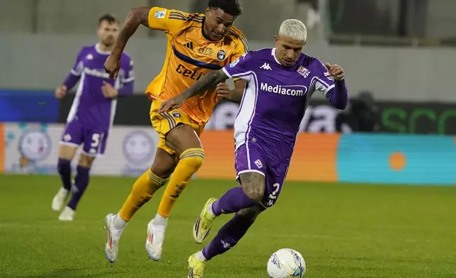 Fiorentina's Dodo, right, and Pisa's Henrik Meister in action during the Serie A soccer match between Pisa and Fiorentina, in Florence, Italy, Monday, Feb. 23, 2026. (Marco Bucco/LaPresse via AP)