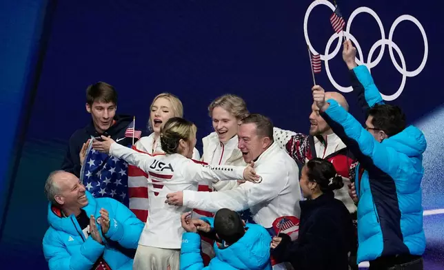 Alysa Lui of the United States reacts to her scores with her team after competing during the figure skating women's team event at the 2026 Winter Olympics, in Milan, Italy, Friday, Feb. 6, 2026. (AP Photo/Ashley Landis)