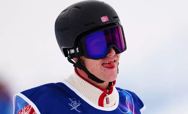Norway's Birk Ruud licks the blood from his lip after winning the gold medal in the men's freestyle skiing slopestyle finals at the 2026 Winter Olympics, in Livigno, Italy, Tuesday, Feb. 10, 2026. (AP Photo/Abbie Parr)