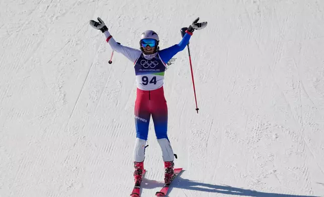 Philippines' Tallulah Proulx celebrates at the finish area of an alpine ski, women's slalom race, at the 2026 Winter Olympics, in Cortina d'Ampezzo, Italy, Wednesday, Feb. 18, 2026. (AP Photo/Andy Wong)