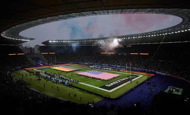 FILE - Fans cheer during the opening ceremony prior to the NFL game between the Indianapolis Colts and the Atlanta Falcons in Berlin, Germany, Nov. 9, 2025. (AP Photo/Markus Schreiber, File)