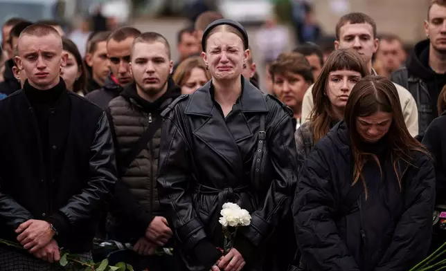 FILE - A woman cries during the funeral ceremony of Ihor Kusochek, a Ukrainian soldier of the Azov brigade in Bobrovytsia, Chernihiv region, Ukraine, Friday, Oct. 4, 2024. (AP Photo/Evgeniy Maloletka, File)