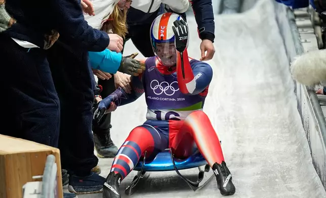 United States' Ashley Farquharson celebrates winning the bronze medal during a women's single luge competition at the 2026 Winter Olympics, in Cortina d'Ampezzo, Italy, Tuesday, Feb. 10, 2026. (AP Photo/Aijaz Rahi)