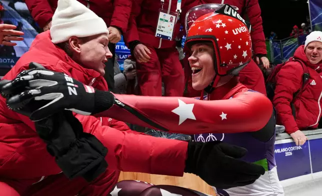 Latvia's Elina Bote celebrates winning the silver medal during the women's single luge competition at the 2026 Winter Olympics, in Cortina d'Ampezzo, Italy, Tuesday, Feb. 10, 2026. (AP Photo/Alessandra Tarantino)