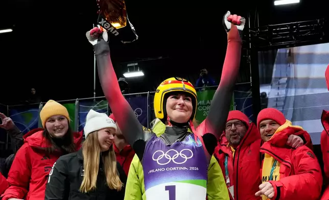 Germany's Julia Taubitz celebrates winning the gold medal during the women's single luge competition at the 2026 Winter Olympics, in Cortina d'Ampezzo, Italy, Tuesday, Feb. 10, 2026. (AP Photo/Alessandra Tarantino)