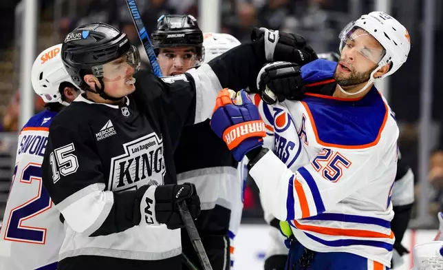 Los Angeles Kings center Alex Turcotte, left, and Edmonton Oilers defenseman Darnell Nurse fight during the second period of an NHL hockey game Thursday, Feb. 26, 2026 in Los Angeles. (AP Photo/Ryan Sun)