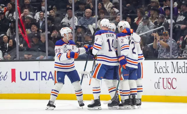 Edmonton Oilers center Connor McDavid, right, celebrates with teammates after scoring during the second period of an NHL hockey game against the Los Angeles Kings Thursday, Feb. 26, 2026 in Los Angeles. (AP Photo/Ryan Sun)