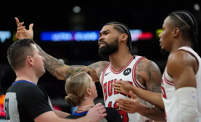 Chicago Bulls center Nick Richards (13) gestures toward Toronto Raptors forward RJ Barrett (9) after a foul during the first half of an NBA basketball game Thursday, Feb. 19, 2026, in Chicago. (AP Photo/Erin Hooley)