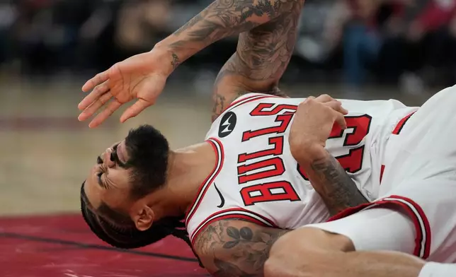 Chicago Bulls center Nick Richards (13) is fouled by Toronto Raptors forward RJ Barrett (9) during the first half of an NBA basketball game Thursday, Feb. 19, 2026, in Chicago. (AP Photo/Erin Hooley)