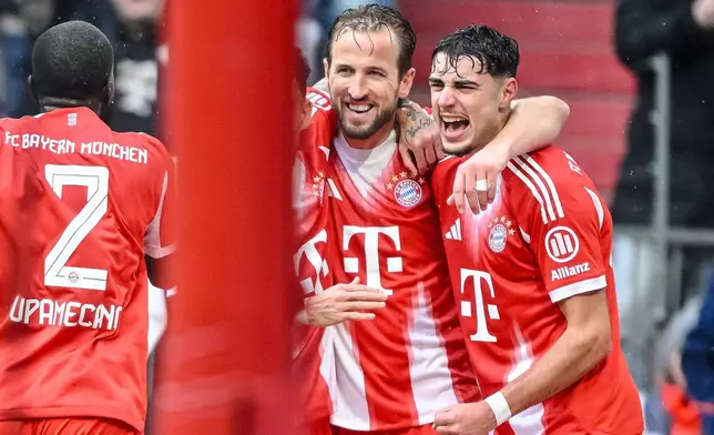 Bayern Munich's Harry Kane, center, celebrates scoring during the Bundesliga soccer match between Bayern Munich and Eintracht Frankfurt in Munich, Germany, Saturday Feb. 21, 2026. (Harry Langer/dpa via AP)