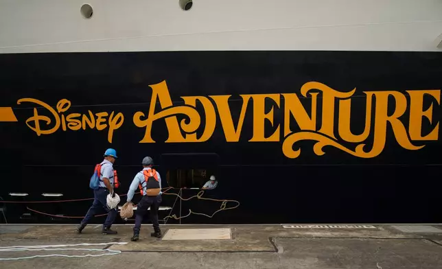 Workers dock The Disney Adventure cruise ship at the Agua Clara locks of the Panama Canal in Colon, Panama, Monday, Feb. 2, 2026. (AP Photo/Matias Delacroix)