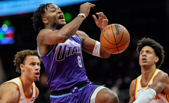 Utah Jazz guard Isaiah Collier (8) shoots against the Atlanta Hawks during the first half of an NBA basketball game, Thursday, Feb. 5, 2026, in Atlanta. (AP Photo/Mike Stewart)