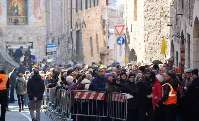 Pilgrims queue to honor the bones of St. Francis during the first public display inside the St. Francis Basilica, marking the 800th anniversary of the saint's death, in Assisi, Italy, Sunday, Feb. 22, 2026.(AP Photo/Gregorio Borgia)