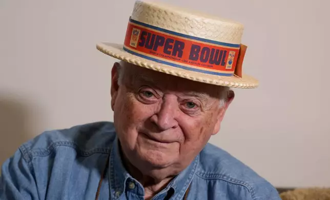 Don Crisman, one of only three remaining members of the "Never Miss a Super Bowl Club" to attend every championship game since 1967, models a souvenir hat from the first game, Friday, Jan. 23, 2026, in Kennebunk, Maine. (AP Photo/Robert F. Bukaty)