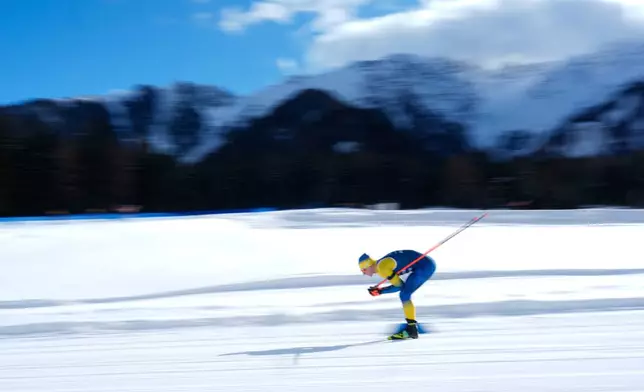 Dmytro Pidruchnyi, of Ukraine, skis during a biathlon training session at the 2026 Winter Olympics in Anterselva, Italy, Monday, Feb. 9, 2026. (AP Photo/Mosa'ab Elshamy)
