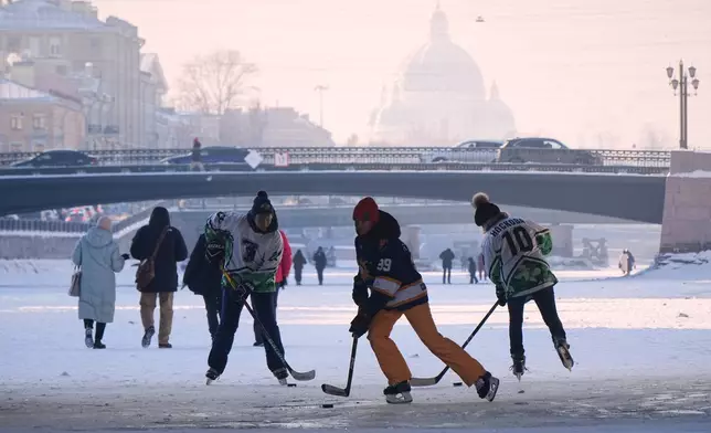 Members of a women's ice hockey team train on the frozen Fontanka River in St. Petersburg, Russia, Friday, Feb. 6, 2026. (AP Photo/Dmitri Lovetsky)
