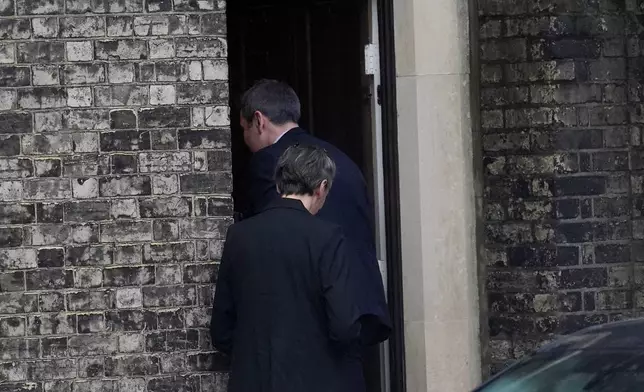 Two people enter the home of Lord Peter Mandelson in north west London, Friday, Feb. 6, 2026. (Maja Smiejkowska/PA via AP)