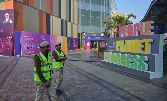 Security people walk at the venue of AI-Summit in New Delhi, India, Monday, Feb. 16, 2026. (AP Photo)