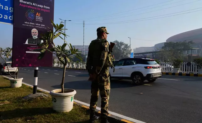 An Indian para-military force soldier stands guard outside the venue of AI-Summit in New Delhi, India, Monday, Feb. 16, 2026. (AP Photo/Manish Swarup)