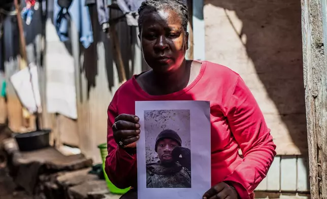 Susan Khandasi Kuloba, 41, the mother of David Shitanda, one of the Kenyans who joined the Russian army in Ukraine, holds his photo during an interview with The Associated Press in the informal settlement of Kibera, Nairobi, Thursday, Jan. 29, 2026. (AP Photo/Samson Otieno)