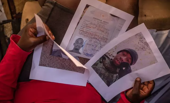 Susan Khandasi Kuloba, 41, the mother of David Shitanda, one of the Kenyans who joined the Russian army in Ukraine, holds his photo during an interview with The Associated Press in the informal settlement of Kibera, Nairobi, Thursday, Jan. 29, 2026. (AP Photo/Samson Otieno)