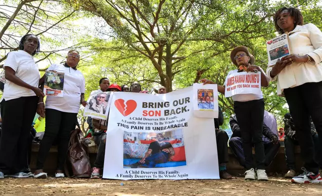 Family members of Kenyans who joined the Russian army in Ukraine hold photos of their loved ones during a protest calling on the government to urgently repatriate them and their remains in Nairobi, Thursday, Feb. 19, 2026. (AP Photo/Andrew Kasuku)