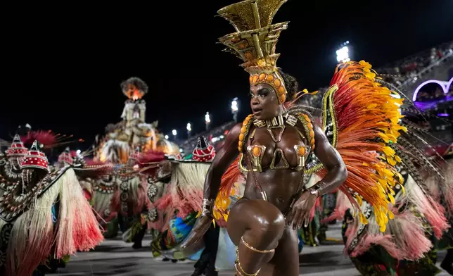 A performer from the Imperio Serrano samba school parades during Carnival celebrations at the Sambadrome in Rio de Janeiro, early Sunday, Feb. 15, 2026. (AP Photo/Bruna Prado)