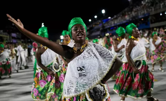 Performers from the Imperio Serrano samba school parade during Carnival celebrations at the Sambadrome in Rio de Janeiro, early Sunday, Feb. 15, 2026. (AP Photo/Bruna Prado)