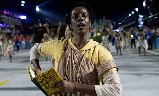 A performer from the Unidos da Tijuca samba school parades during Carnival celebrations at the Sambadrome in Rio de Janeiro, early Tuesday, Feb. 17, 2026. (AP Photo/Bruna Prado)