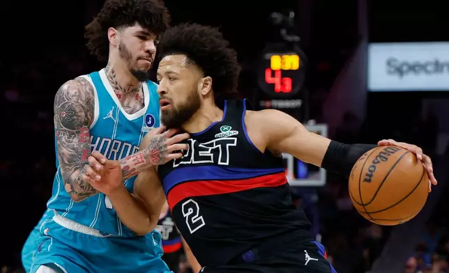 Detroit Pistons guard Cade Cunningham (2) drives against Charlotte Hornets guard LaMelo Ball, left, during the first half of an NBA basketball game in Charlotte, N.C., Monday, Feb. 9, 2026. (AP Photo/Nell Redmond)