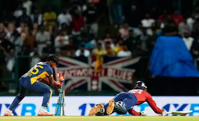 Sri Lanka's Janith Liyanage unsuccessfully attempts a run out as England's Tom Banton successfully completes a run during the second T20 cricket match between England and Sri Lanka in Pallekele, Sri Lanka, Sunday, Feb, 1. 2026. (AP Photo/Eranga Jayawardena)
