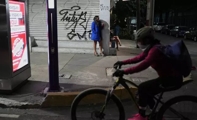 Montserrat Fuentes stands on Calzada de Tlalpan where she has worked as a sex worker for 20 years and the city is building a new bike lane ahead of the World Cup soccer tournament, blocking cars from pulling over and closing the metro at night, in Mexico City, Friday, Jan. 30, 2026. (AP Photo/Eduardo Verdugo)
