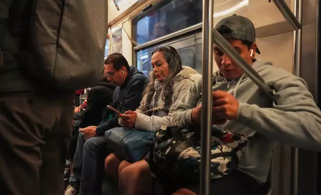 Montserrat Fuentes, a sex worker, rides the metro to Calzada de Tlalpan, the street in Mexico City where the city is building a bike lane in preparation for the World Cup that blocks cars from pulling over, cutting into the livelihoods of sex workers and street vendors, and closes the metro early, Tuesday, Feb. 10, 2026. (AP Photo/Eduardo Verdugo)