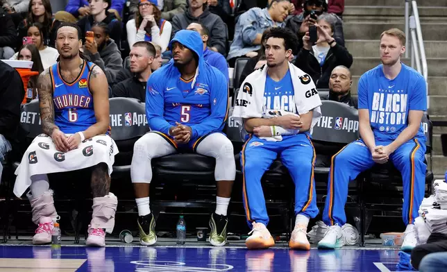 Oklahoma City Thunder forward Jaylin Williams (6), guard Luguentz Dort (5), guard Jared McCain and forward Buddy Boeheim, right, sit on the bench with the Thunder shorthanded with five of their six leading scorers out injured during the second half of an NBA basketball game against the Detroit Pistons, Wednesday, Feb. 25, 2026, in Detroit. (AP Photo/Duane Burleson)