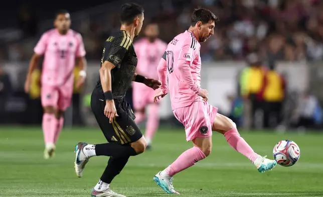 Inter Miami forward Lionel Messi, right, passes against Los Angeles FC midfielder Mark Delgado (8) dribbles the ball during the first half of an MLS soccer match, Saturday, Feb. 21, 2026, in Los Angeles, Calif. (AP Photo/Jessie Alcheh)