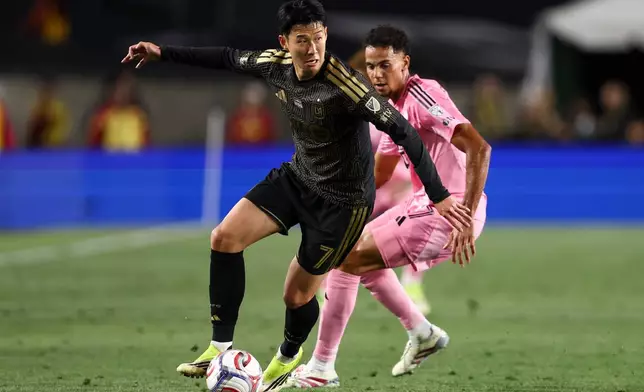 Los Angeles FC forward Son Heung-Min (7) dribbles against Inter Miami defender Ian Fray, back right, during the first half of an MLS soccer match, Saturday, Feb. 21, 2026, in Los Angeles, Calif. (AP Photo/Jessie Alcheh)