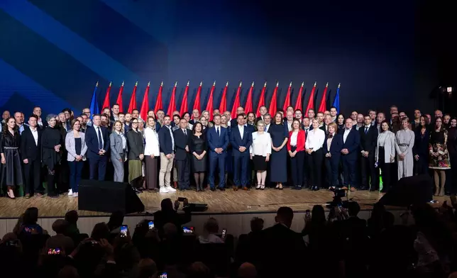 Péter Magyar, center, leader of the opposition Tisza party who will challenge Prime Minister Viktor Orbán in national elections on April 12. poses for a group photo with all the candidates of the party, after their campaign opener event in Budapest, Hungary on Sunday, Feb. 15, 2026. (AP Photo/Denes Erdos)