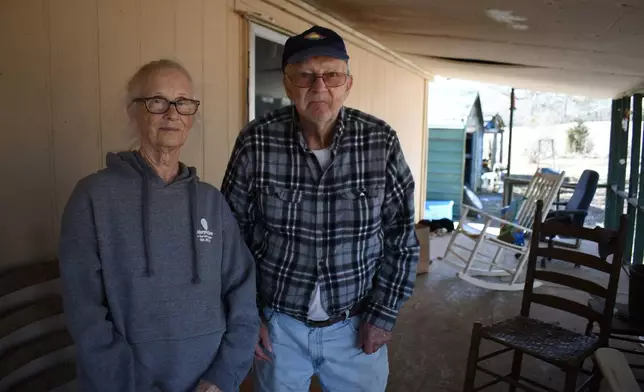 Barbara Bishop, 79, left, and her husband George Bishop, 85, pose for a portrait on their front porch, Friday, Feb. 6, 2026 in Oxford, Ms. (AP Photo/Sophie Bates)