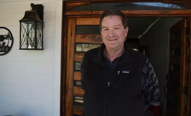 Russ Jones, whose home has not had power in 13 days, stands on his front porch on Friday, Feb. 6, 2026 in Oxford, Ms. (AP Photo/Sophie Bates)