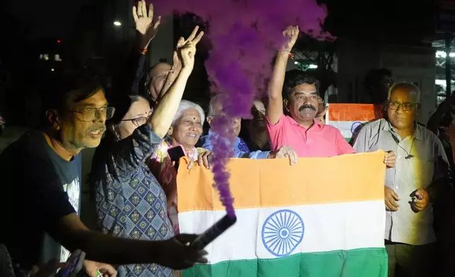 Indian fans celebrate Indian team's victory against Pakistan in ICC men's T20 World Cup cricket match played at Colombo in Sri Lanka, in Ahmedabad, India, Sunday, Feb. 15, 2026. (AP Photo/Ajit Solanki)