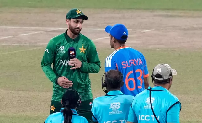 Pakistan's captain Salman Ali Agha, left, looks at India's captain Suryakumar Yadav after the coin toss of the T20 World Cup cricket match between India and Pakistan in Colombo, Sri Lanka, Sunday, Feb. 15, 2026. (AP Photo/Eranga Jayawardena)