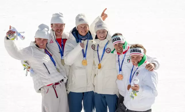 Silver medalists Ben Ogden and Gus Schumacher, of the United States, gold medalist Johannes Hoesflot Klaebo and Einar Hedegart, of Norway, and bronze medalist Elia Barp and Federico Pellegrino, of Italy, pose after the cross-country skiing men's team sprint free at the 2026 Winter Olympics, in Tesero, Italy, Wednesday, Feb. 18, 2026. (AP Photo/Evgeniy Maloletka)