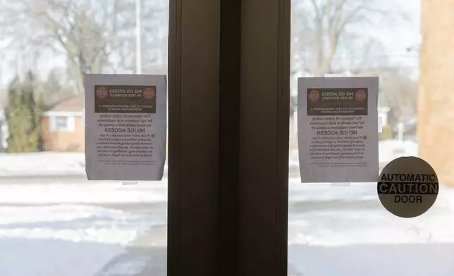 Signs reading "NO ICE ACCESS" taped to the front doors of Valley View Elementary School, Tuesday, Feb. 3, 2026, in Columbia Heights, Minn. (AP Photo/Liam James Doyle)