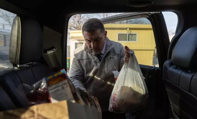 Valley View Elementary School principal Jason Kuhlman delivers food donations to families from the school Tuesday, Feb. 3, 2026, in Columbia Heights, Minn. (AP Photo/Liam James Doyle)