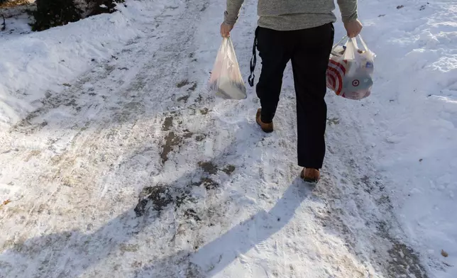 Valley View Elementary School principal Jason Kuhlman delivers food donations to families from the school Tuesday, Feb. 3, 2026, in Columbia Heights, Minn. (AP Photo/Liam James Doyle)