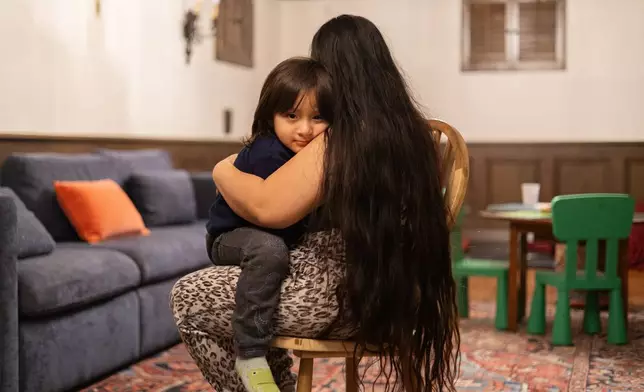 Yair, 3, sits for a portrait with his mom at home Tuesday, Feb. 3, 2026, in Minneapolis. (AP Photo/Liam James Doyle)