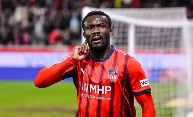 Heidenheim's Sirlord Conteh celebrates scoring during the Bundesliga soccer match between FC Heidenheim and VfB Stuttgart in Heidenheim, Germany, Sunday Feb. 22, 2026. (Harry Langer/dpa via AP)