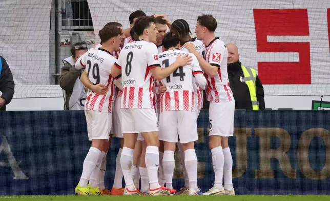 Freiburg players celebrate a goal during the Bundesliga soccer match between SC Freiburg and Borussia Mönchengladbach in Freiburg, Germany, Sunday Feb. 22, 2026. (Philipp von Ditfurth/dpa via AP)