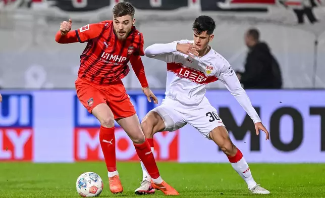 Heidenheim's Julian Niehues, left, and Stuttgart's Chema Andrés in action during the Bundesliga soccer match between FC Heidenheim and VfB Stuttgart in Heidenheim, Germany, Sunday Feb. 22, 2026. (Harry Langer/dpa via AP)